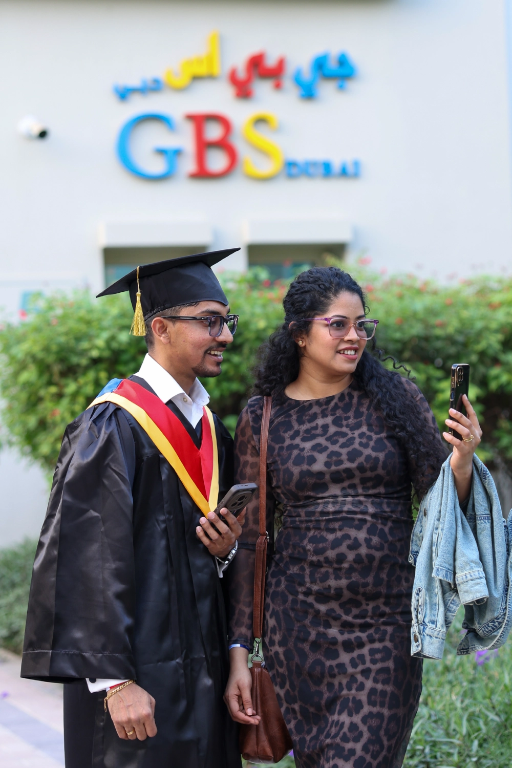 A graduate and guest outside GBS Dubai