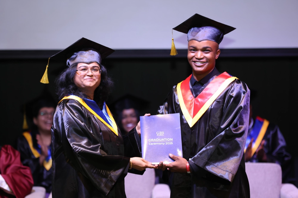 A graduate receiving a certificate on stage