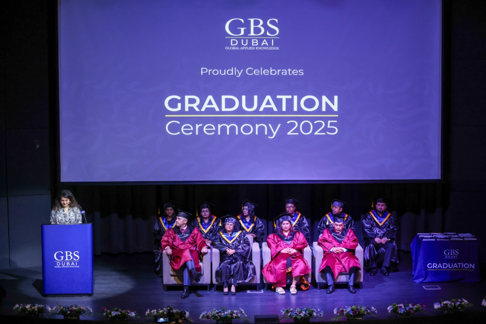 Academic procession members seated on the graduation stage
