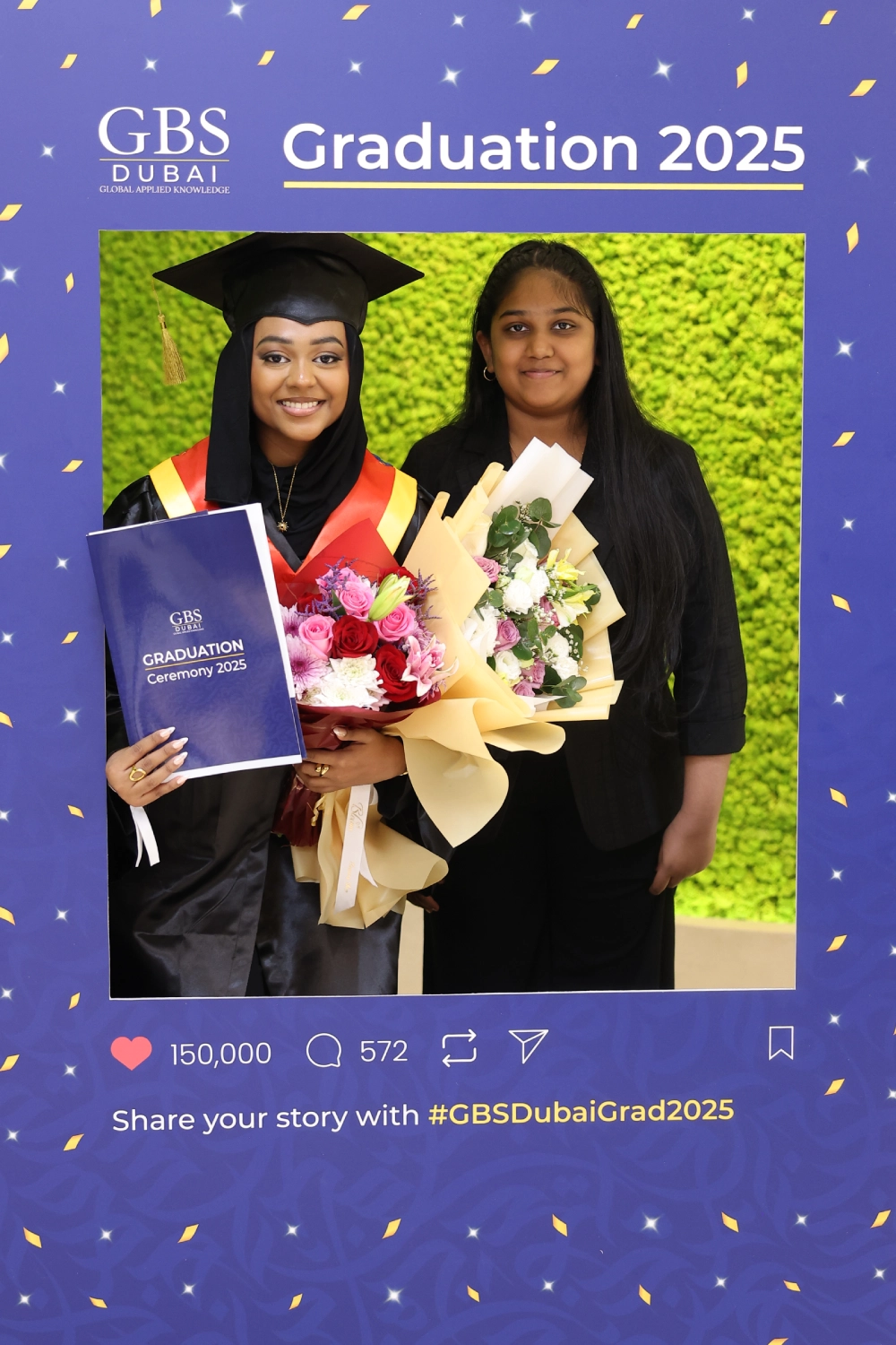 A graduate celebrating beside the graduation photo frame