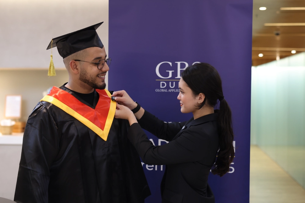 A graduate preparing for the ceremony